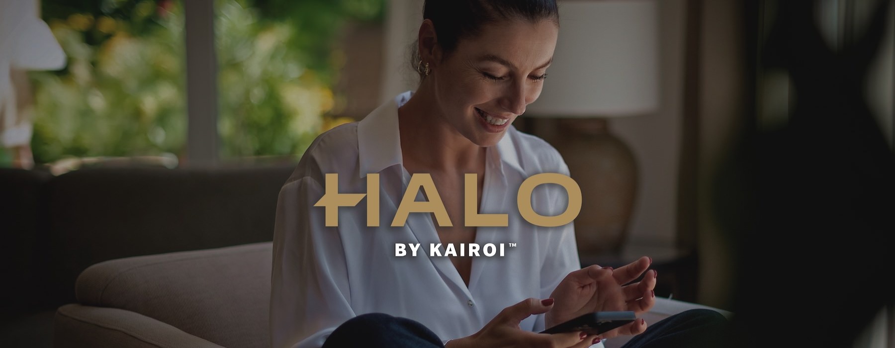 a woman smiling and interacting with her device