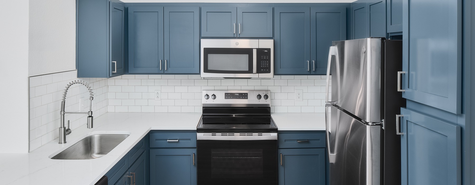 blue cabinets with stainless steel appliances 