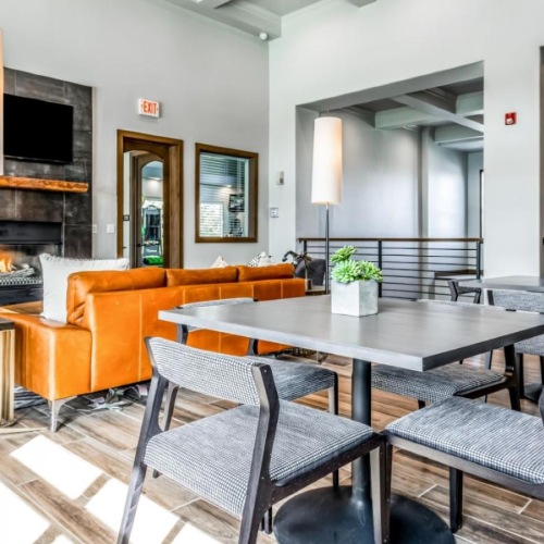 Everything within reach a clubroom with a table chairs and a fireplace