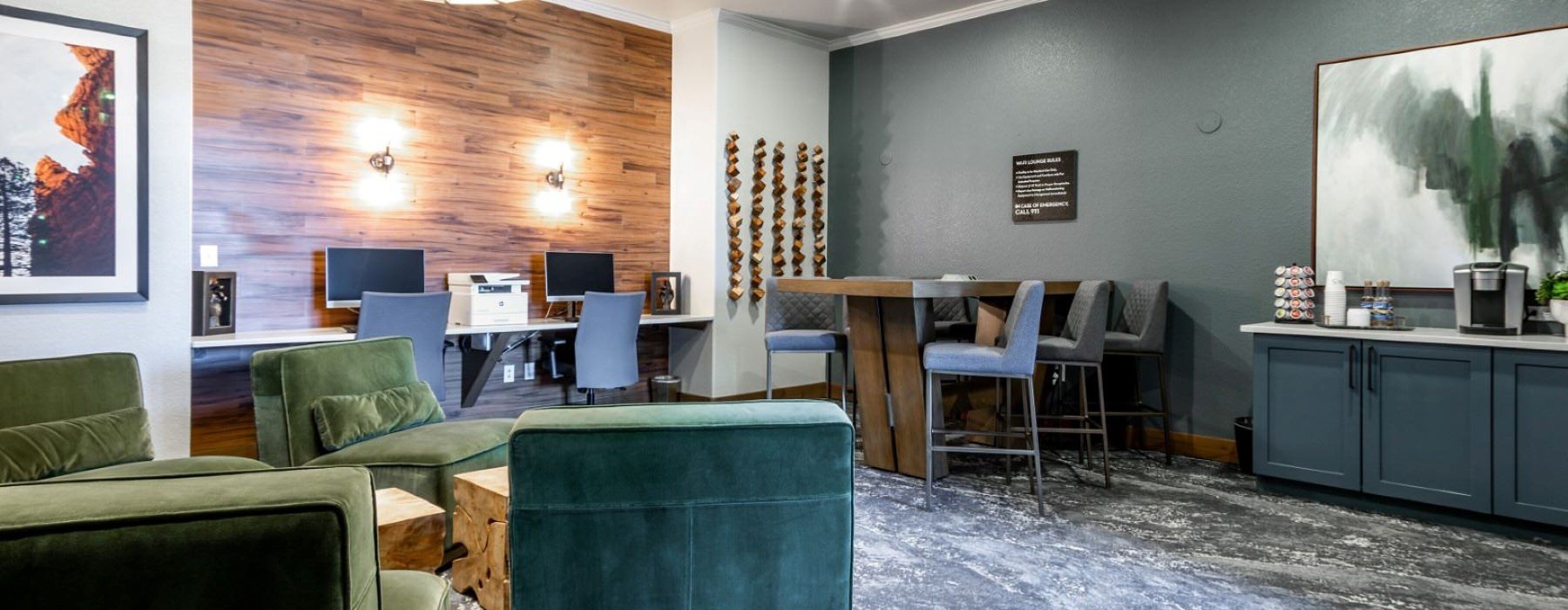 Cutting-edge amenities at your fingertips a clubroom with green couches and a table