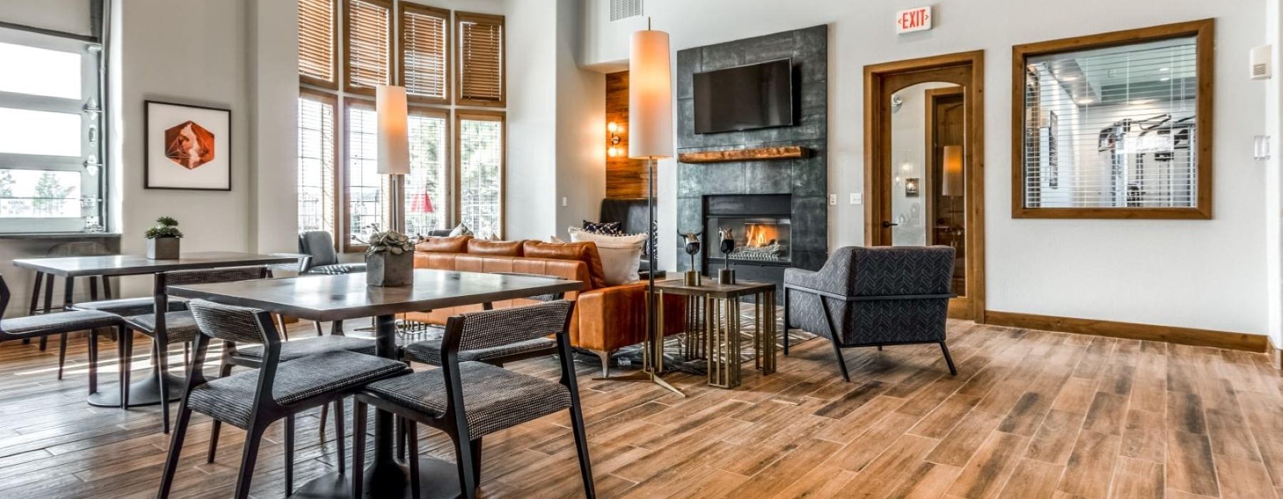 State-of-the-art amenities a clubroom with a fireplace and chairs