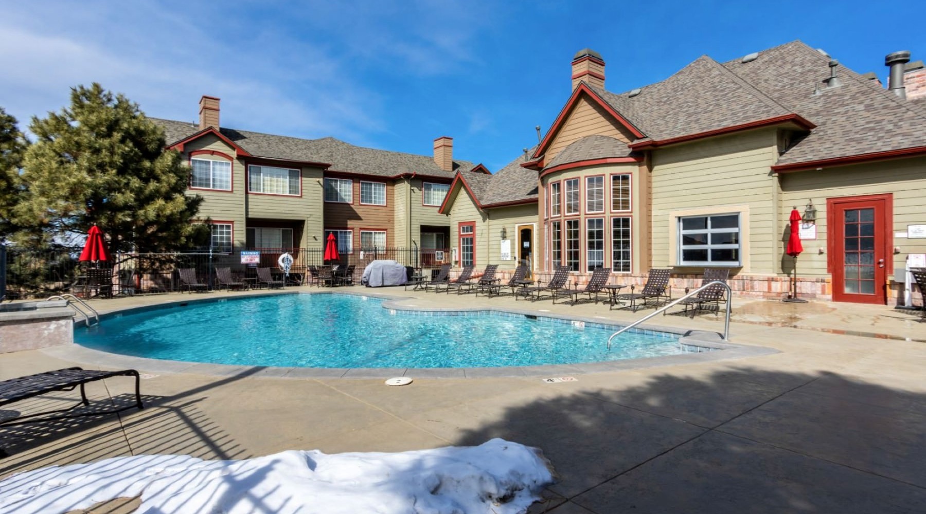 Resort-style swimming pool a swimming pool in front of a building