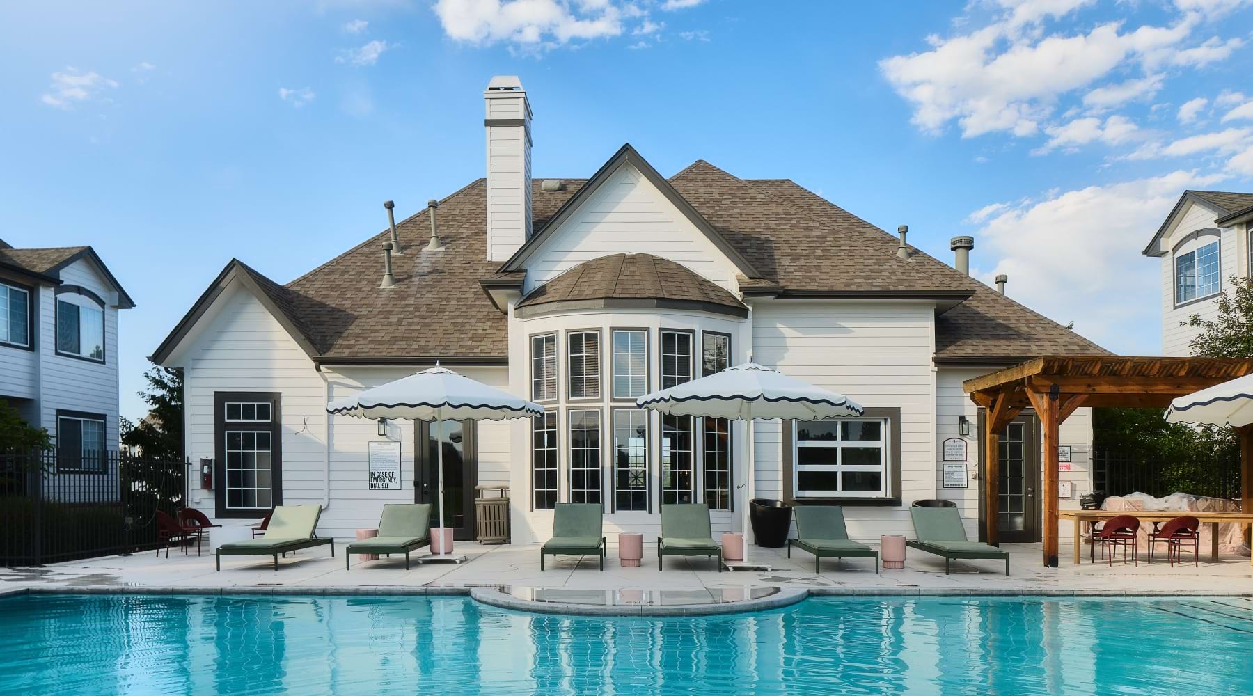 pool with lounge chairs and building