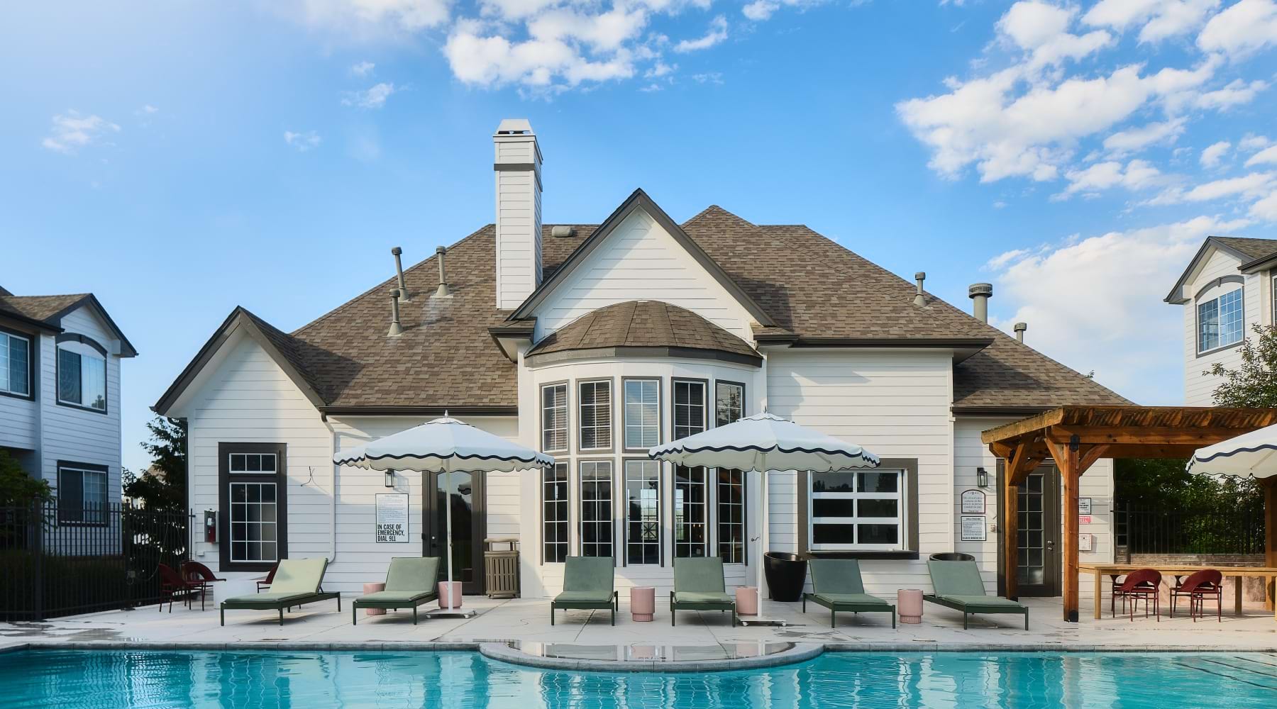 pool with lounge chairs and building