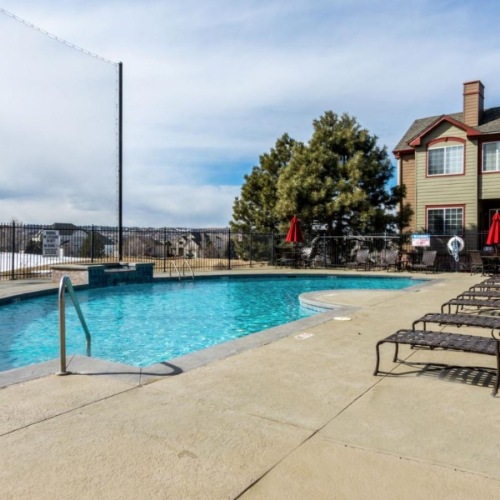 Shimmering resort-style pool a swimming pool with a bench