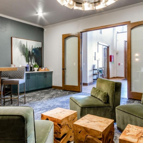 a clubroom with green couches